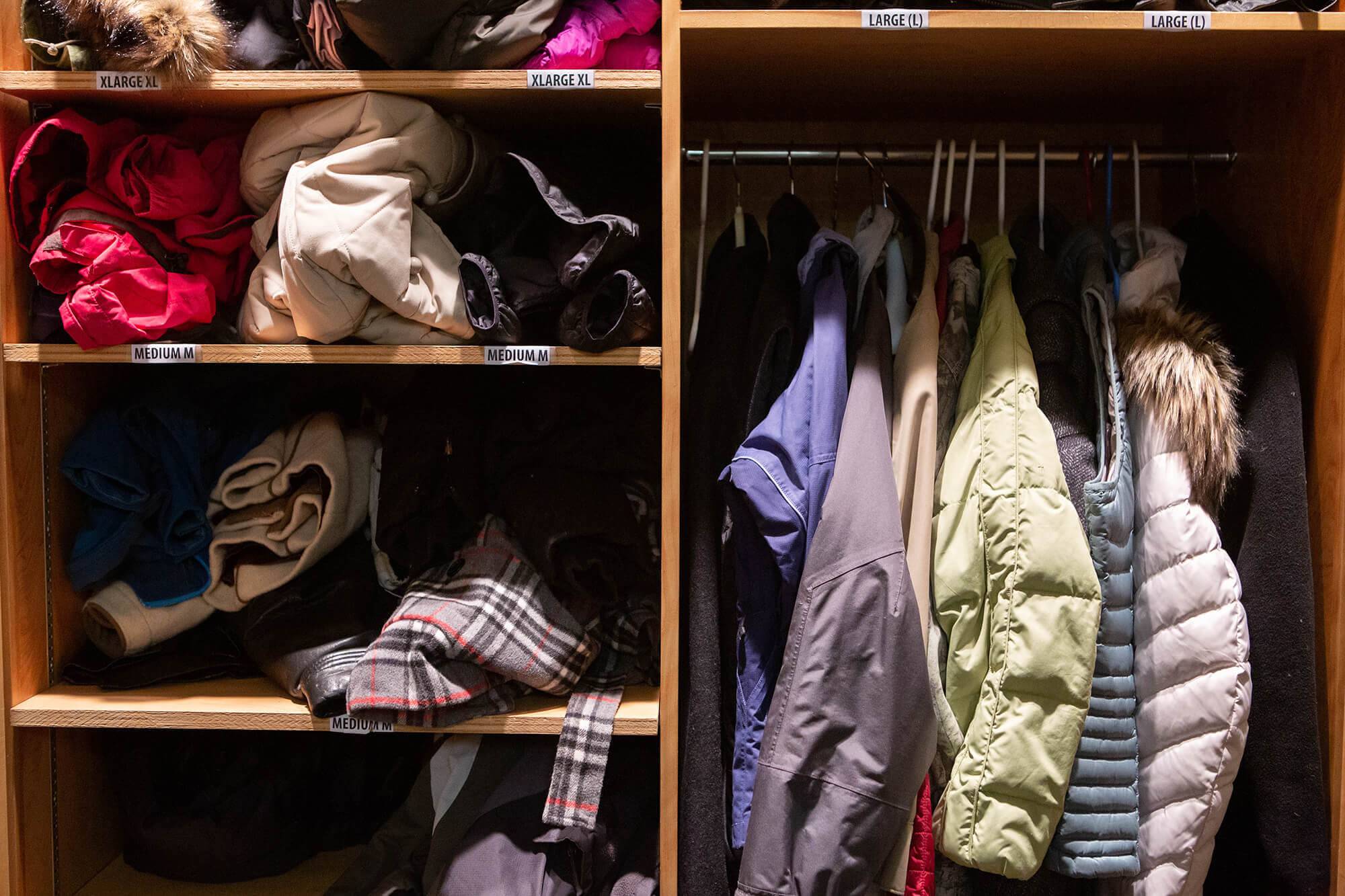 A closet of collected coats in the Office of Integrative Learning and Advising